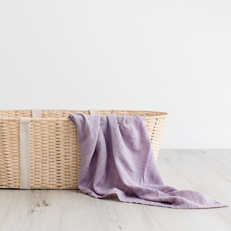 Purple organic cotton muslin swaddle in basket 