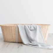 Baby grey organic cotton muslin swaddle in basket