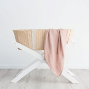 Pink organic cotton baby muslin swaddle in basket