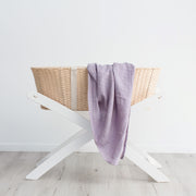 Purple organic cotton swaddle in baby basket