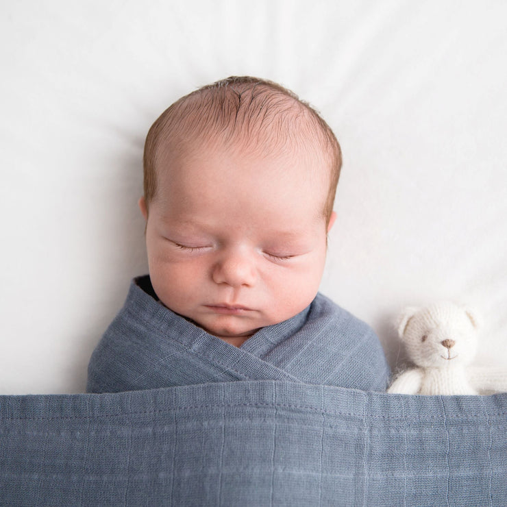 Blue organic cotton muslin swaddle baby wrapped
